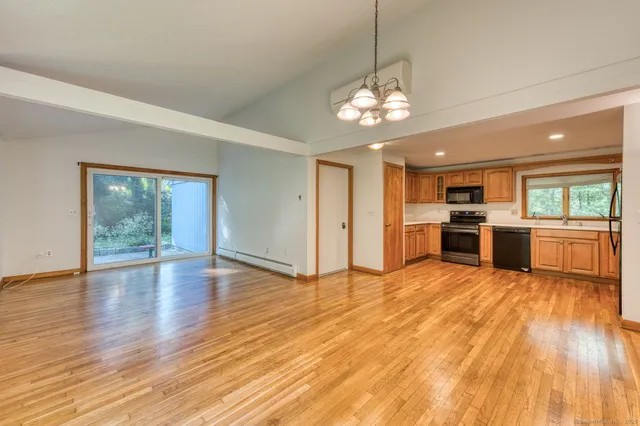 a view of a kitchen with stove and wooden floor