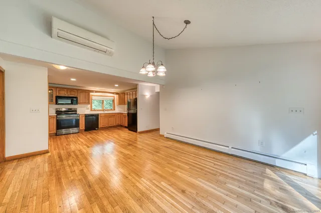 a view of a kitchen with a sink and wooden floor
