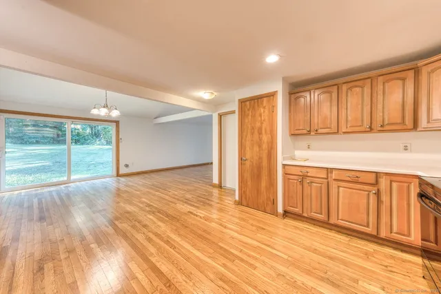 a view of a kitchen with wooden floor and a sink