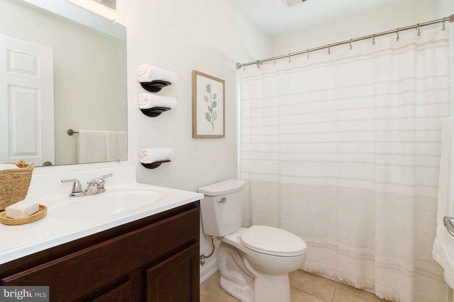 2608 Burridge Road Parkville, MD 21234 - Photo 5 of 15 a bathroom with a sink a toilet and shower curtain