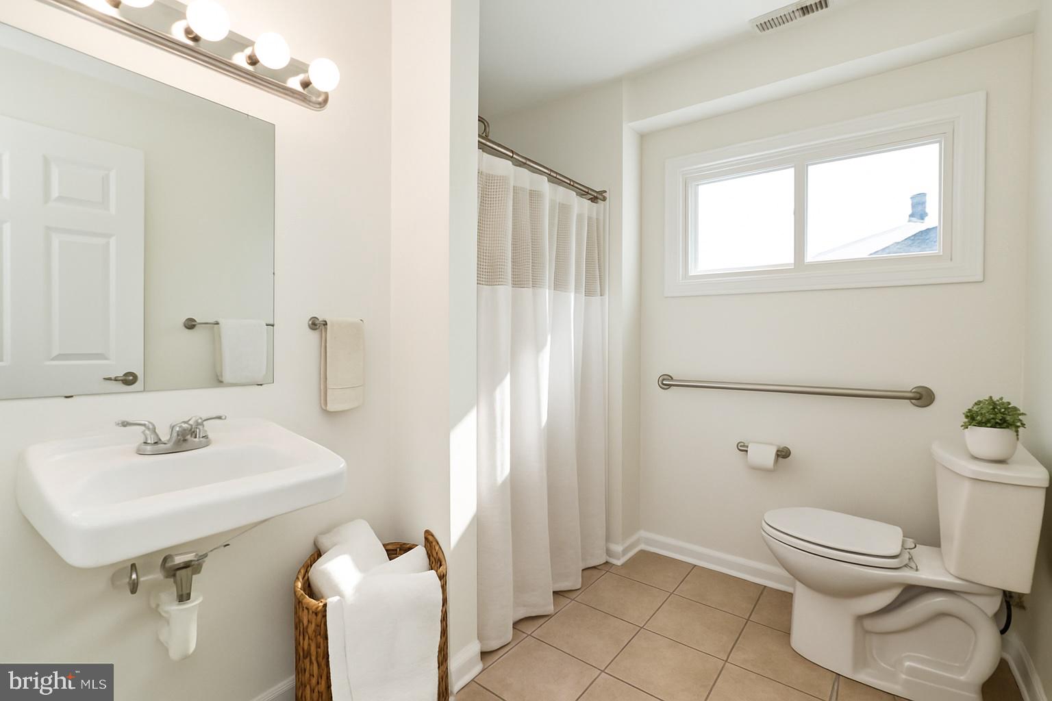 2608 Burridge Road Parkville, MD 21234 - Photo 7 of 15 a bathroom with a sink toilet and shower