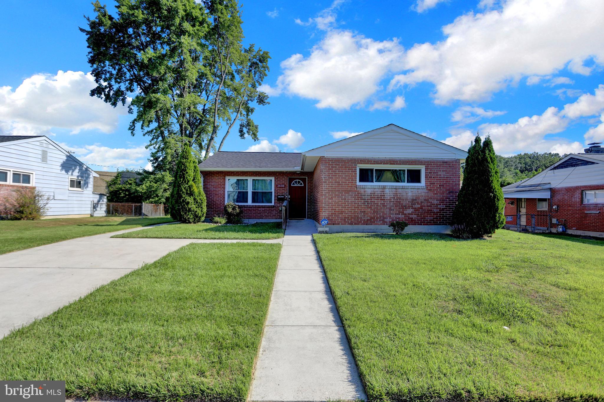 2608 Burridge Road Parkville, MD 21234 - Photo 8 of 15 a front view of a house with a yard and potted plants
