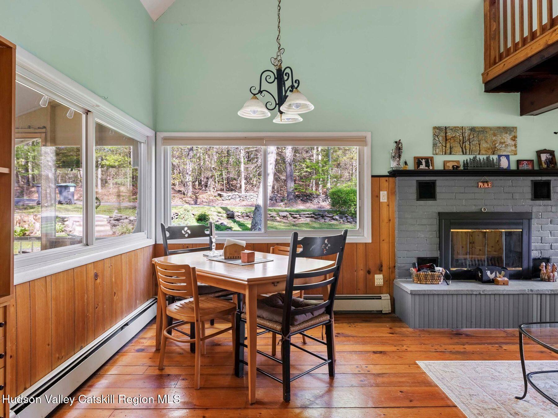 32 Ridge Road Shokan, NY 12481 - Photo 8 of 32 a dining room with furniture a floor to ceiling window and wooden floor
