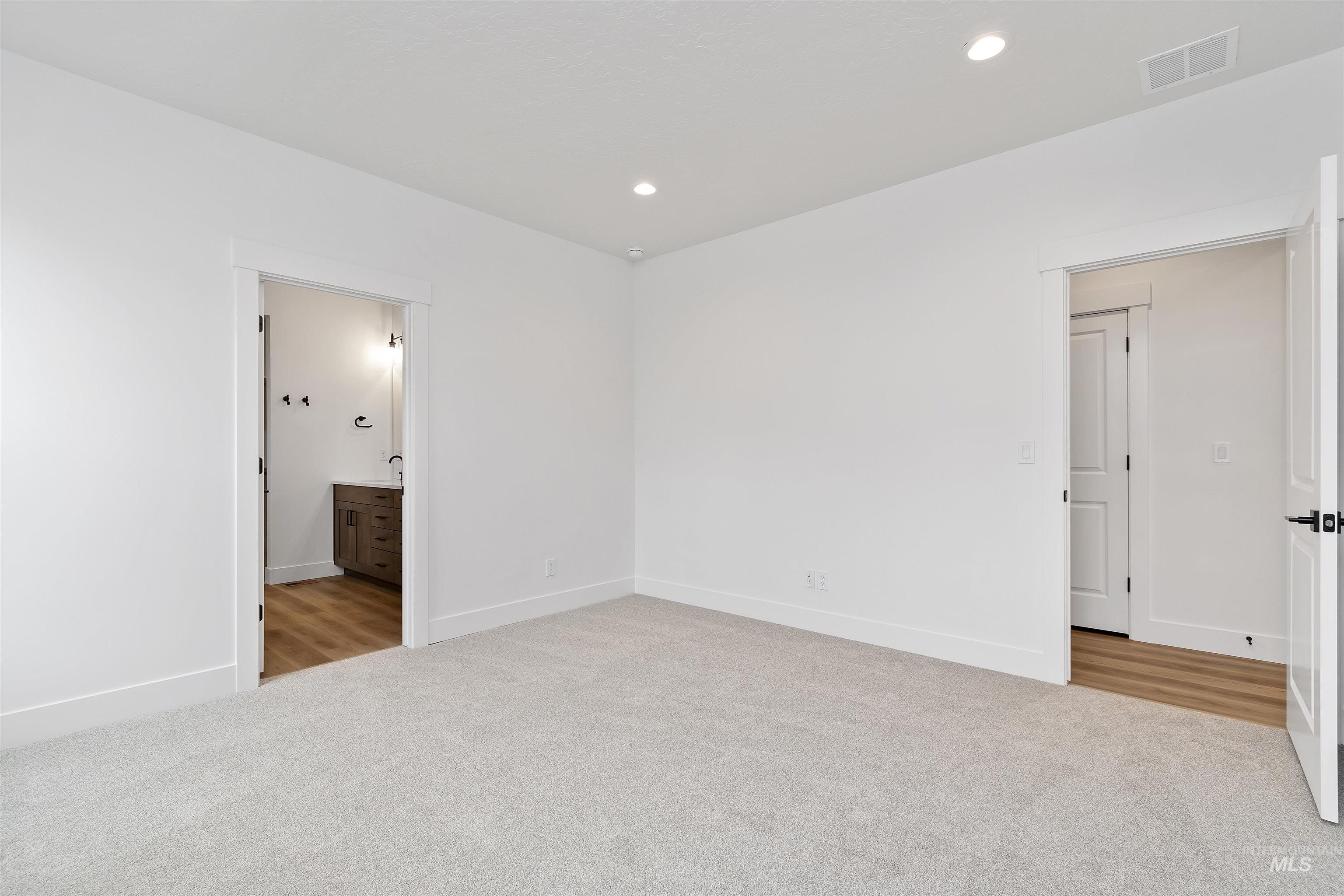 764 South Calhoun Lane Star, ID 83669 - Photo 37 of 48 Unfurnished bedroom with light carpet, connected bathroom, and recessed lighting
