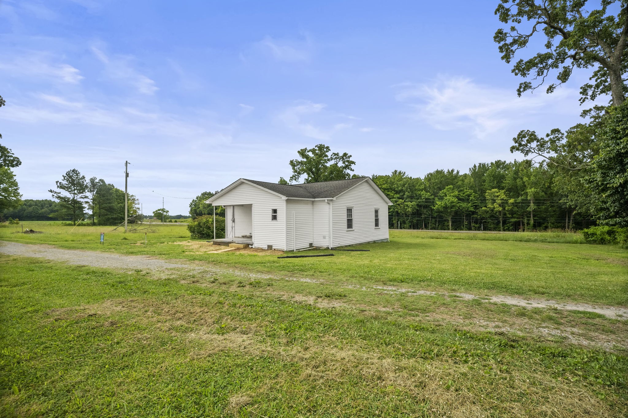 7230 Highway 49 E Springfield Tn 37172 East Springfield, TN 37172 - Photo 30 of 33 a house view with garden space and trees in the background