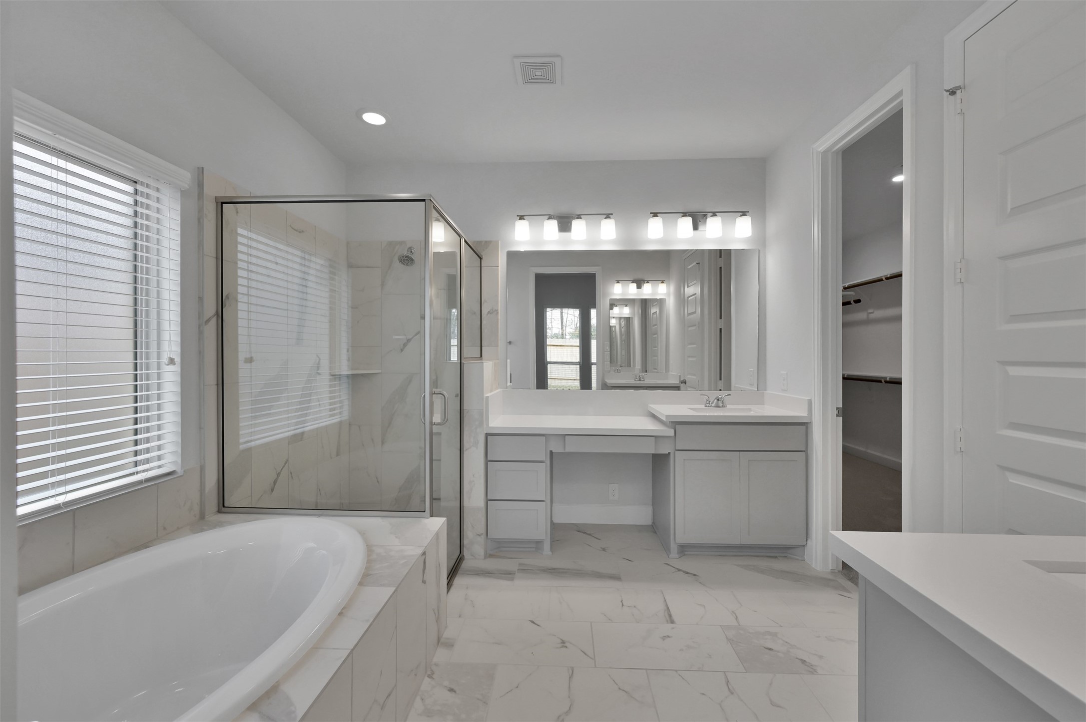 15715 Autumn Sun Conroe, TX 77302 - Photo 15 of 23 a bathroom with a tub a sink shower and mirror