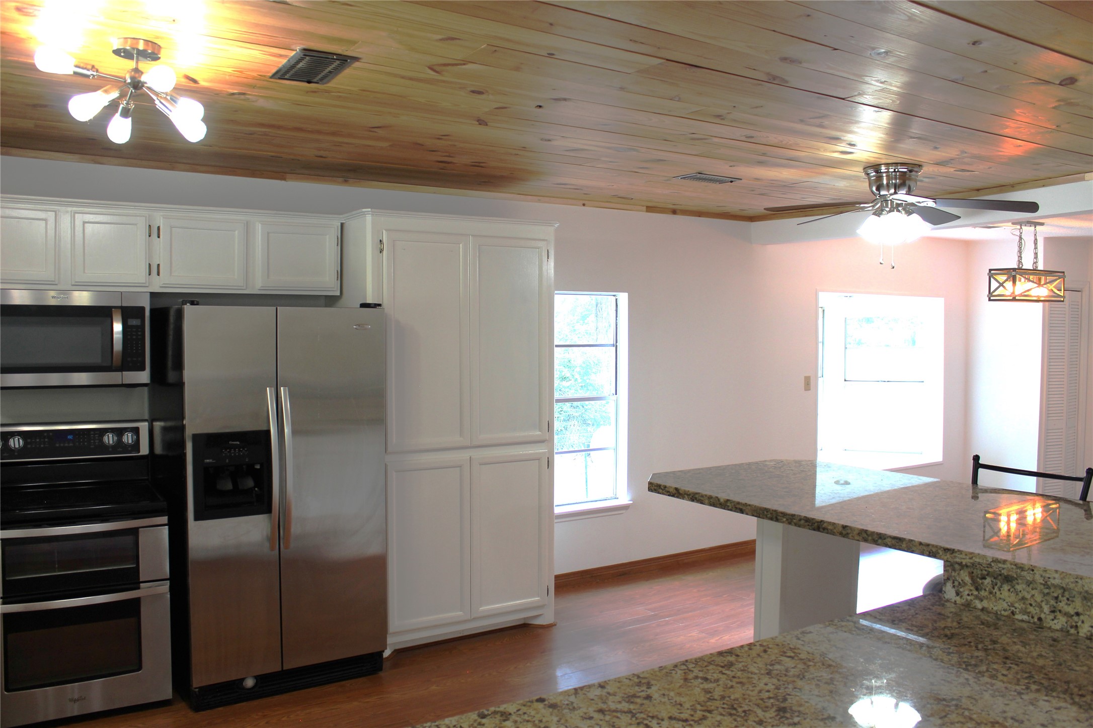 14040 FM 1484 Road Conroe, TX 77303 - Photo 11 of 47 a kitchen with kitchen island a counter top space appliances and a window