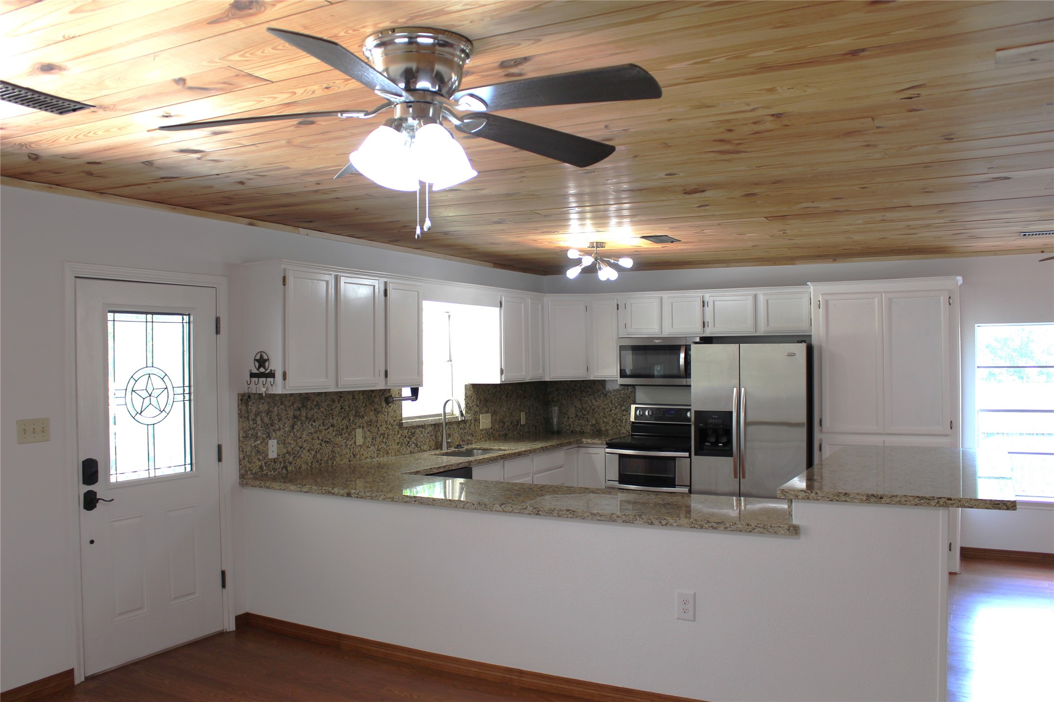 14040 FM 1484 Road Conroe, TX 77303 - Photo 17 of 47 a kitchen with stainless steel appliances granite countertop a sink a window cabinets and stainless steel appliances