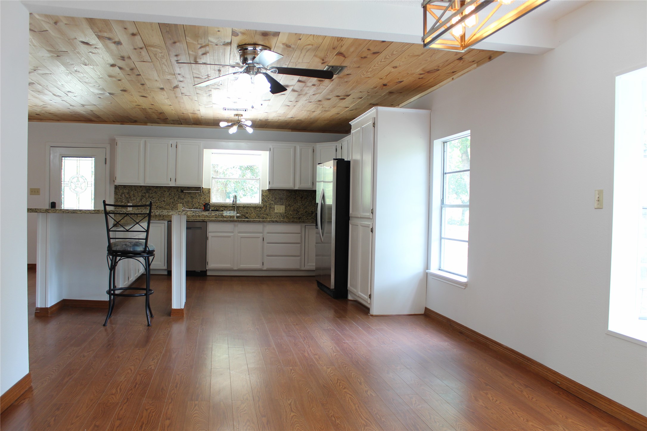 14040 FM 1484 Road Conroe, TX 77303 - Photo 18 of 47 a kitchen with stainless steel appliances granite countertop a refrigerator a sink dishwasher a stove and white countertops with wooden floor