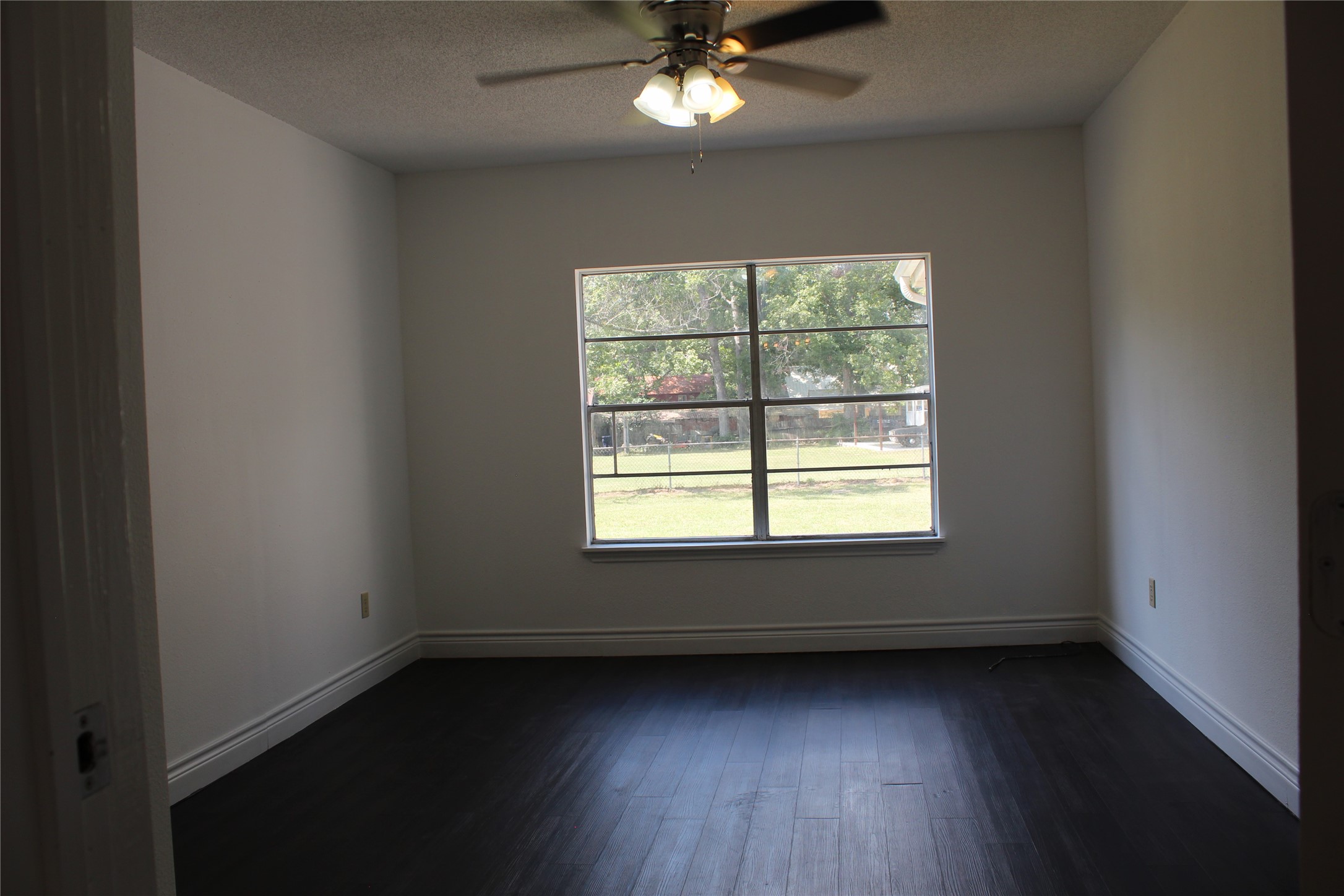 14040 FM 1484 Road Conroe, TX 77303 - Photo 19 of 47 a view of an empty room with wooden floor and a window