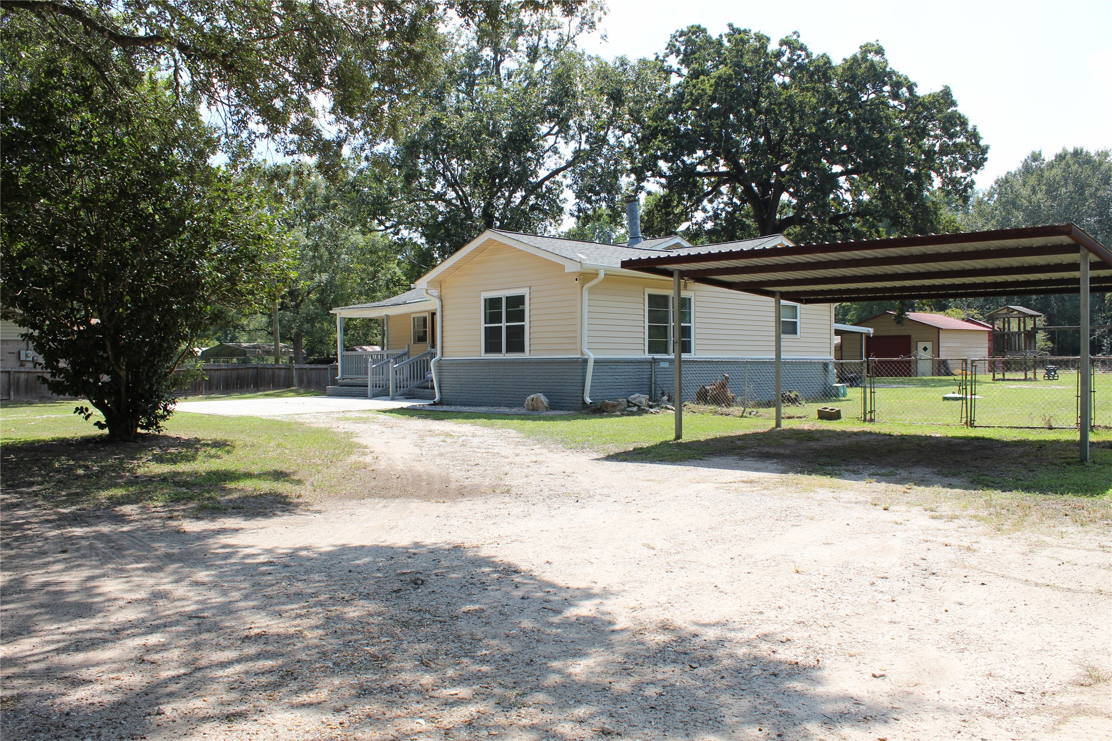 14040 FM 1484 Road Conroe, TX 77303 - Photo 2 of 47 a front view of a house with a yard and trees