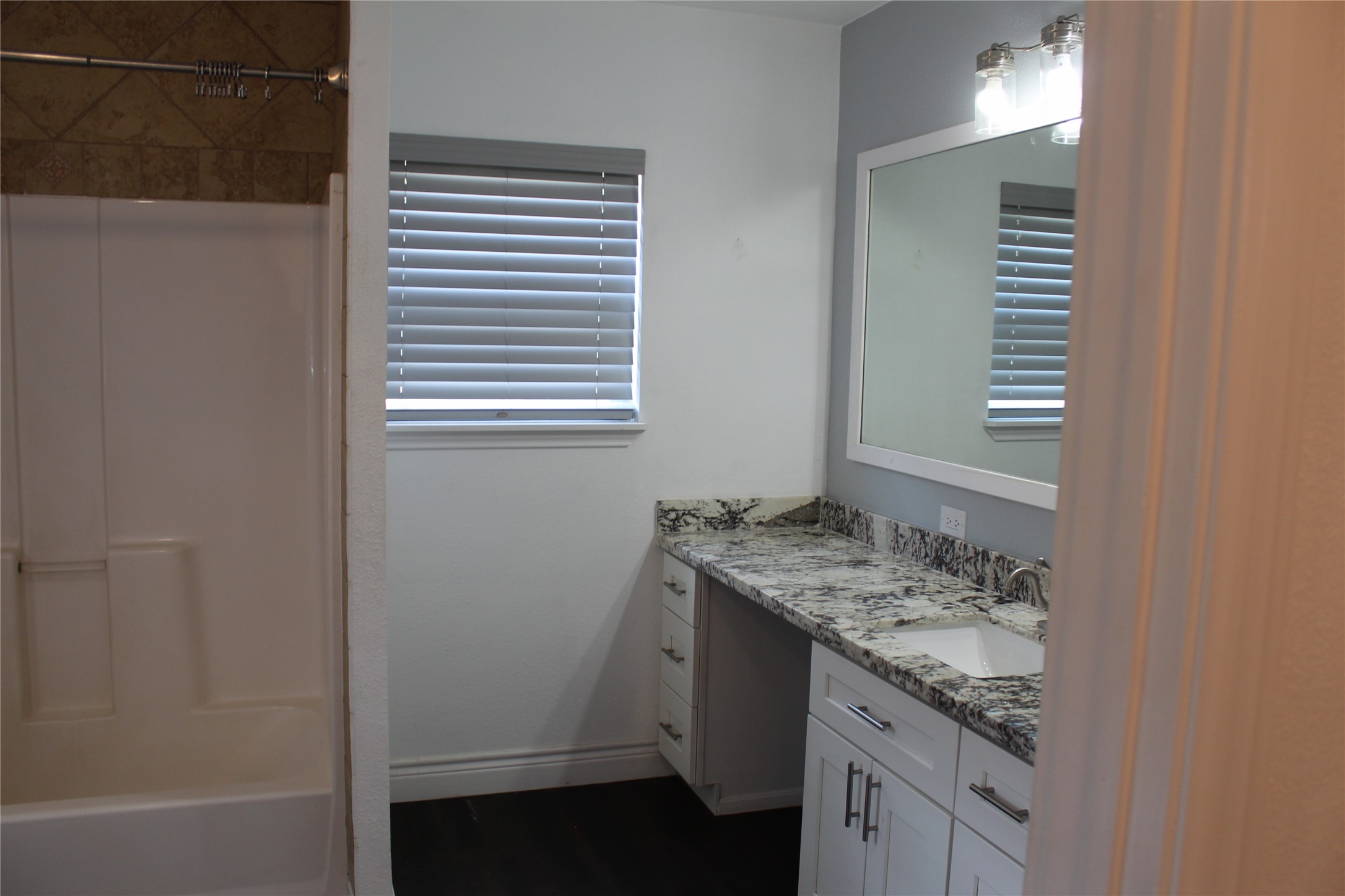 14040 FM 1484 Road Conroe, TX 77303 - Photo 25 of 47 a bathroom with a granite countertop sink and a mirror