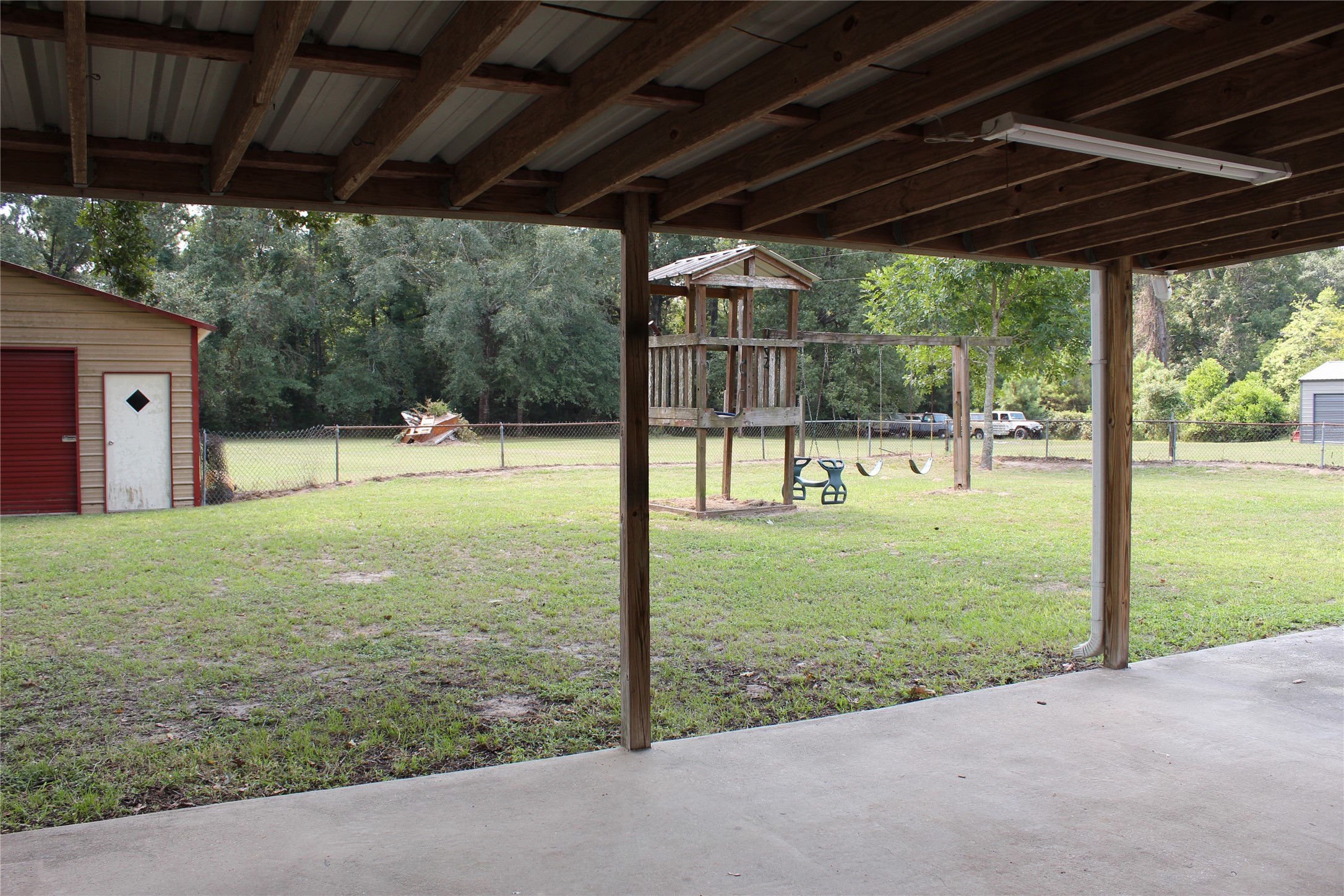 14040 FM 1484 Road Conroe, TX 77303 - Photo 26 of 47 a view of a backyard with floor to ceiling window and wooden fence