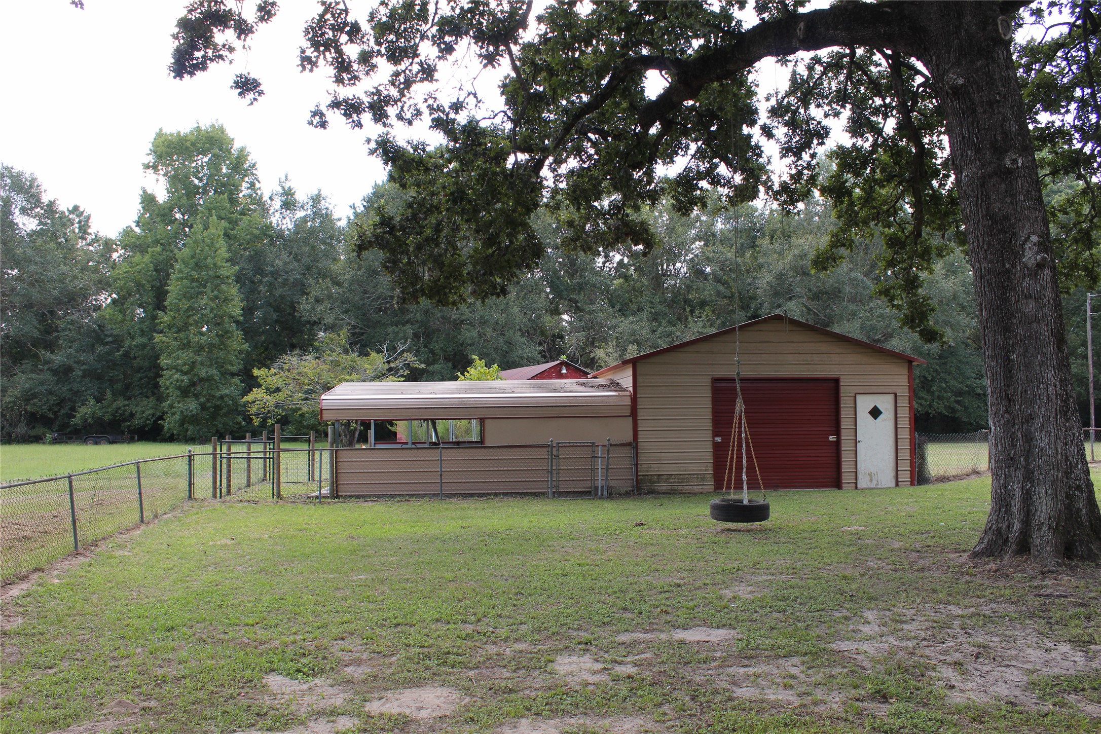 14040 FM 1484 Road Conroe, TX 77303 - Photo 28 of 47 a front view of a house with a garden and yard