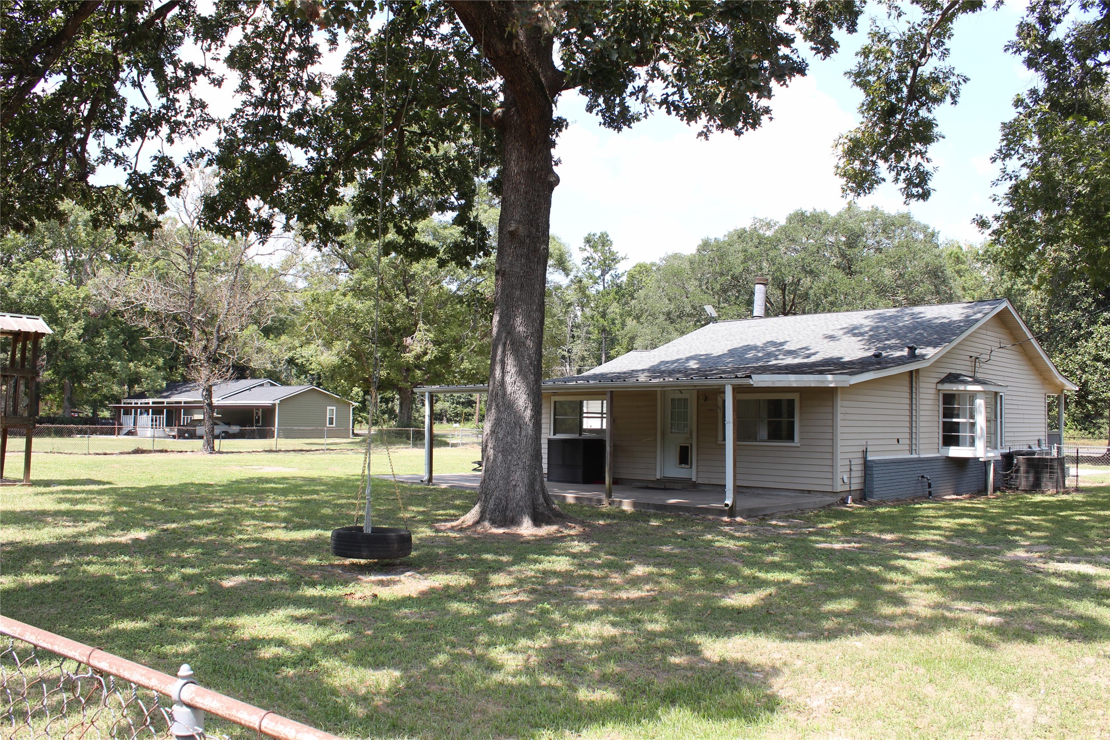 14040 FM 1484 Road Conroe, TX 77303 - Photo 44 of 47 a view of a house with a yard porch and sitting area