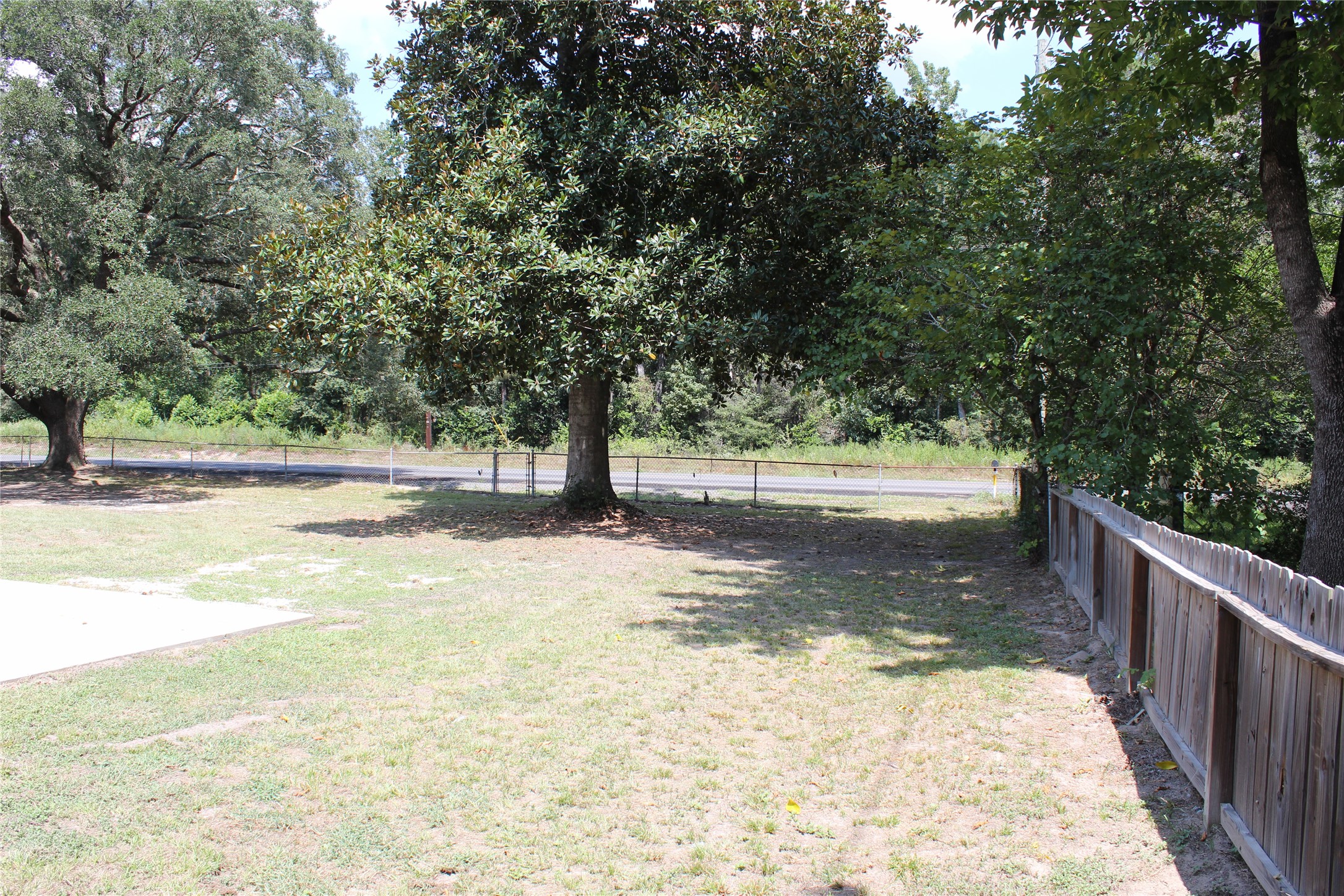 14040 FM 1484 Road Conroe, TX 77303 - Photo 5 of 47 a view of a yard with wooden fence
