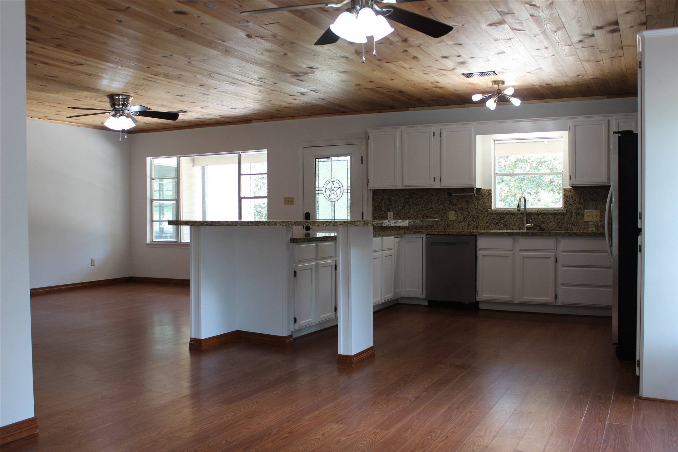 14040 FM 1484 Road Conroe, TX 77303 - Photo 8 of 47 a kitchen with granite countertop a stove cabinets and wooden floor