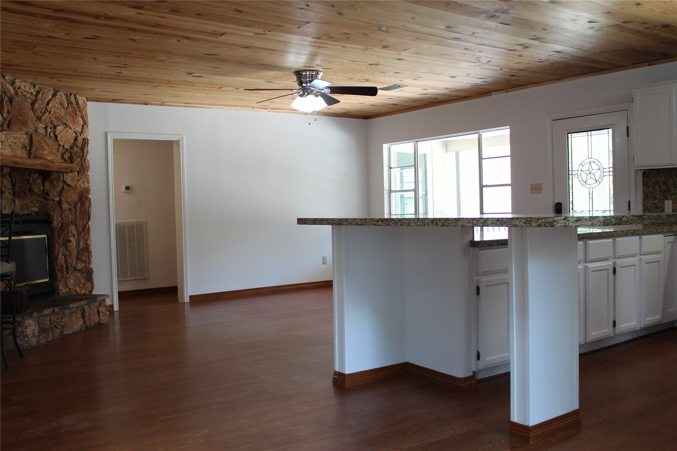 14040 FM 1484 Road Conroe, TX 77303 - Photo 9 of 47 a view of an empty room with wooden floor and a window