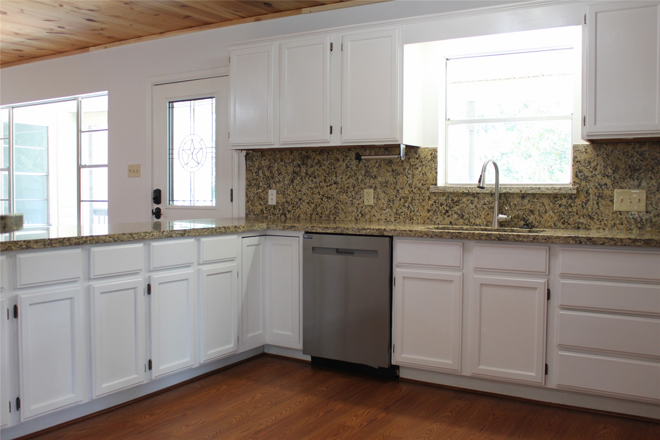 14040 FM 1484 Road Conroe, TX 77303 - Photo 10 of 47 a kitchen with granite countertop white cabinets and a sink