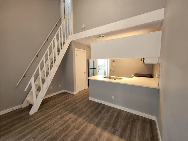 a view of entryway and hall with wooden floor