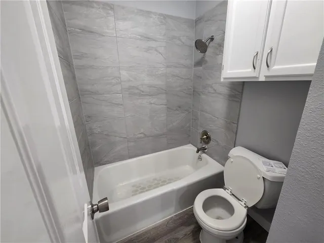 a bathroom with a toilet and a tub