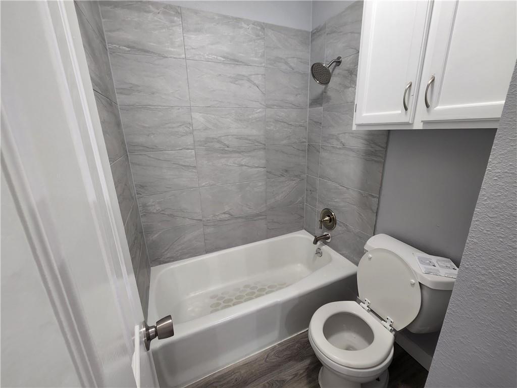 2815 Rio Grande Street, Unit 202 Austin, TX 78705 - Photo 5 of 11 a bathroom with a toilet and a tub