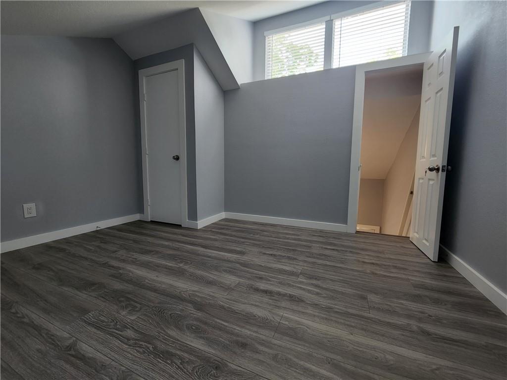 2815 Rio Grande Street, Unit 202 Austin, TX 78705 - Photo 10 of 11 an empty room with wooden floor and windows