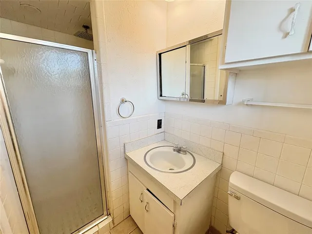 a bathroom with a sink toilet and mirror