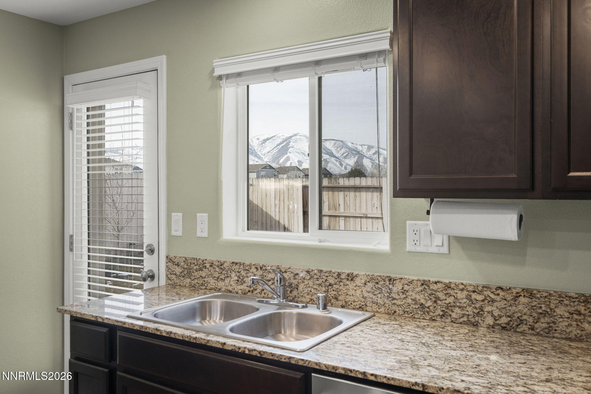 7709 Sandy Valley Drive Reno, NV 89506 - Photo 17 of 35 a kitchen with a sink window and cabinets