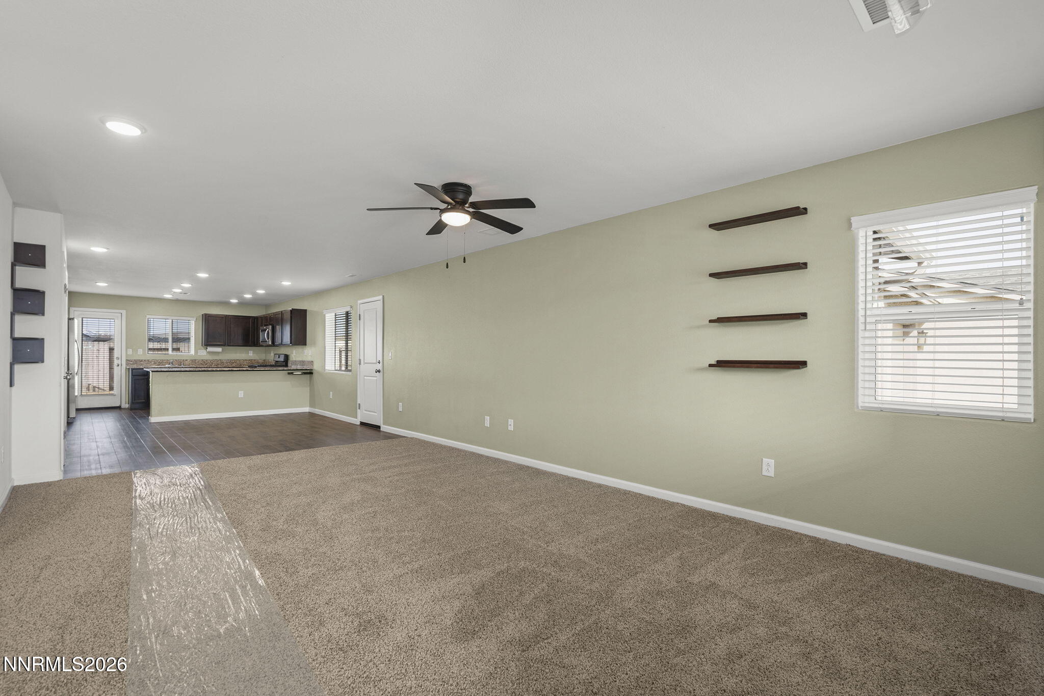 7709 Sandy Valley Drive Reno, NV 89506 - Photo 8 of 35 a view of a livingroom with kitchen and a window