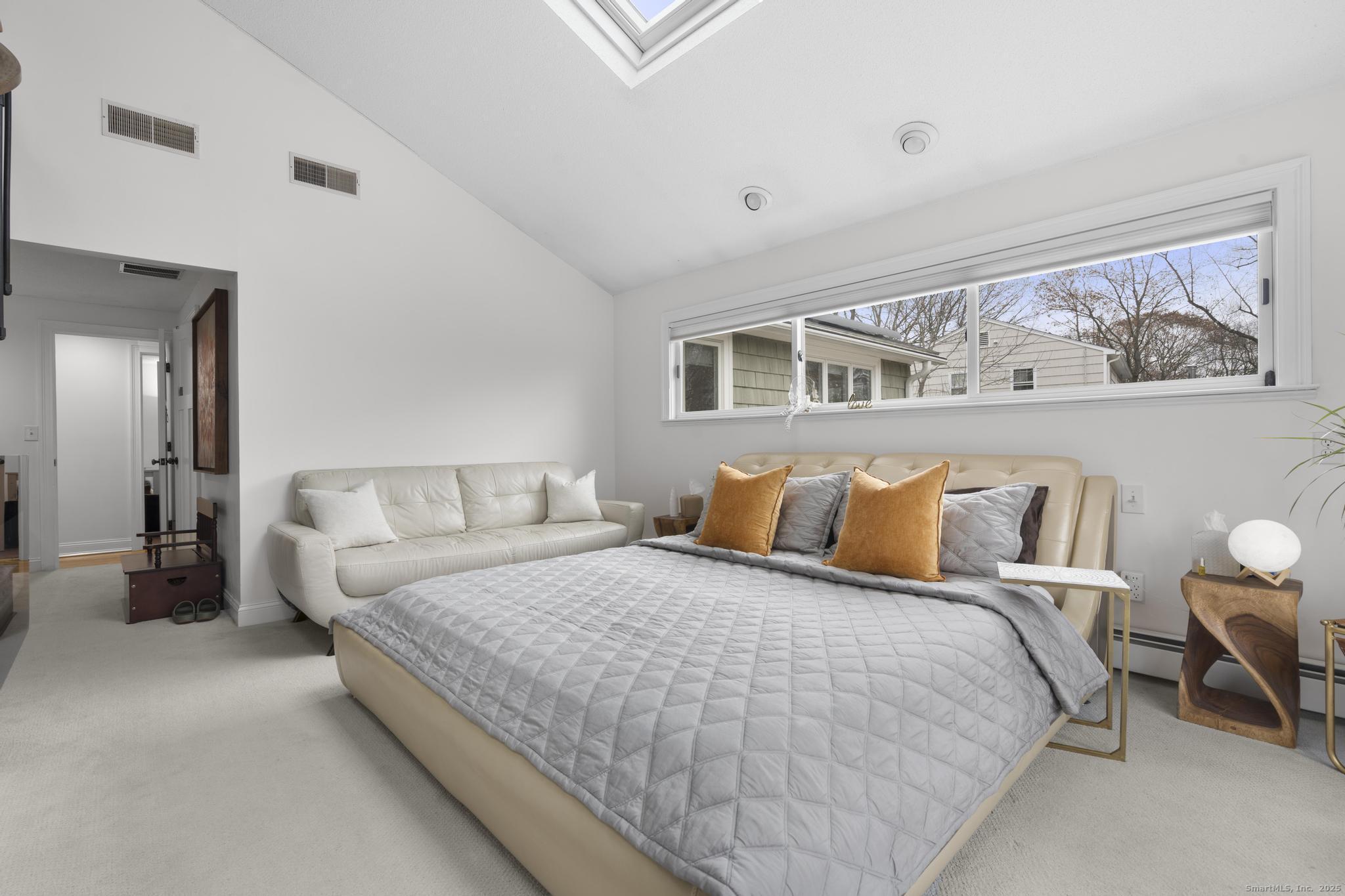 57 Gray Rock Road Trumbull, CT 06611 - Photo 12 of 40 a bedroom with a large bed and paintings on the wall