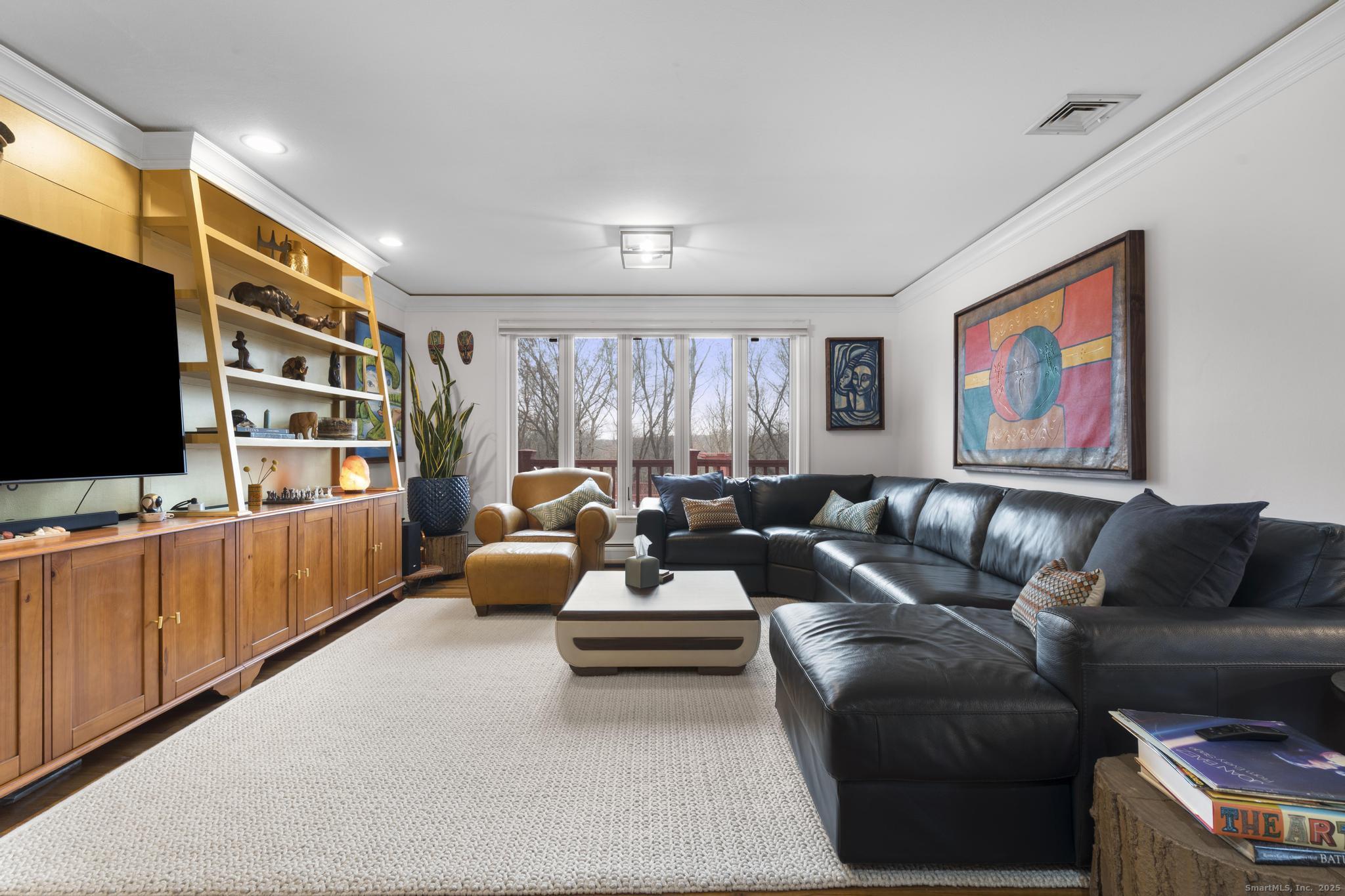 57 Gray Rock Road Trumbull, CT 06611 - Photo 17 of 40 a living room with furniture and a flat screen tv