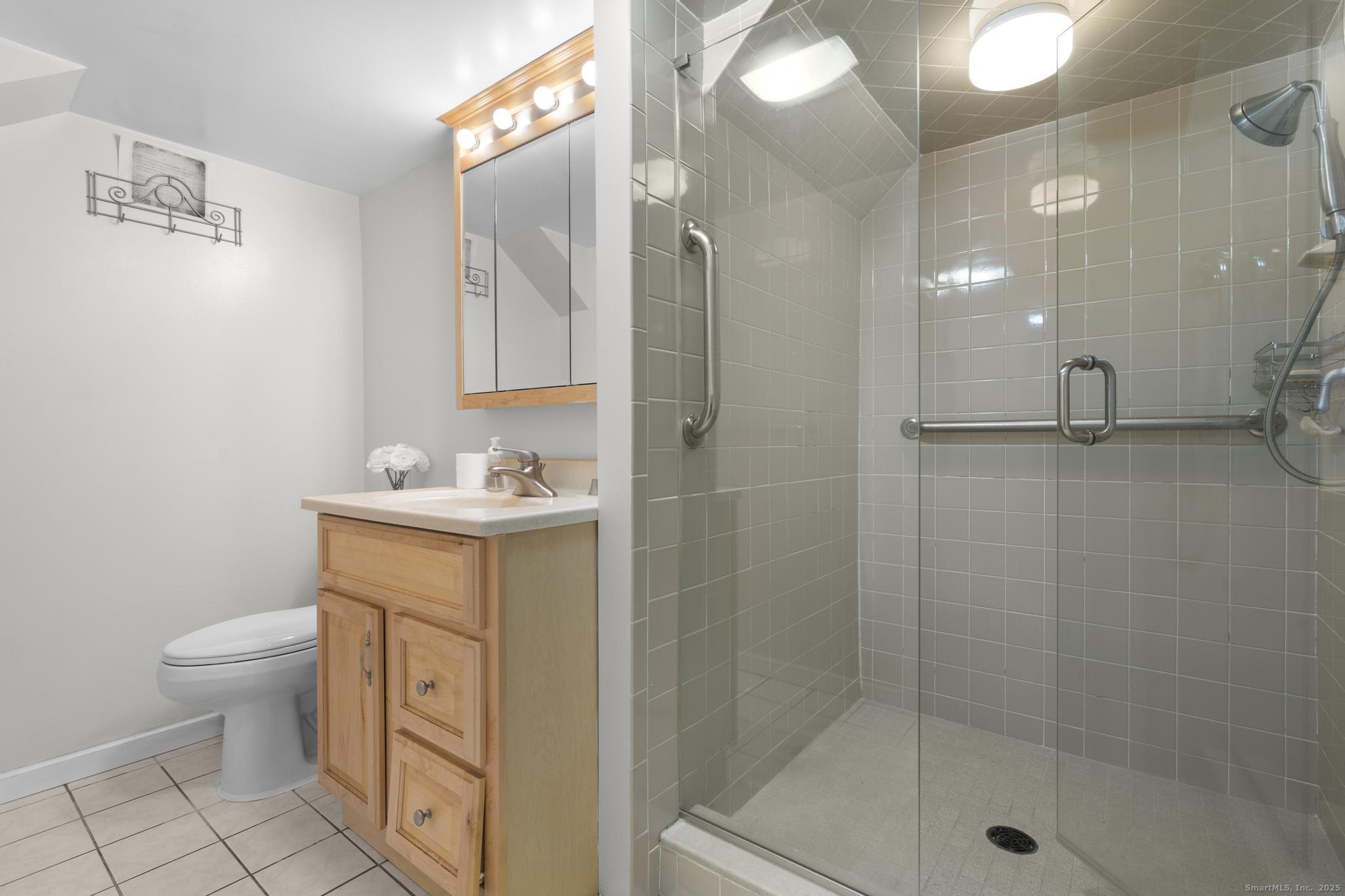 57 Gray Rock Road Trumbull, CT 06611 - Photo 33 of 40 a bathroom with a sink a toilet and shower