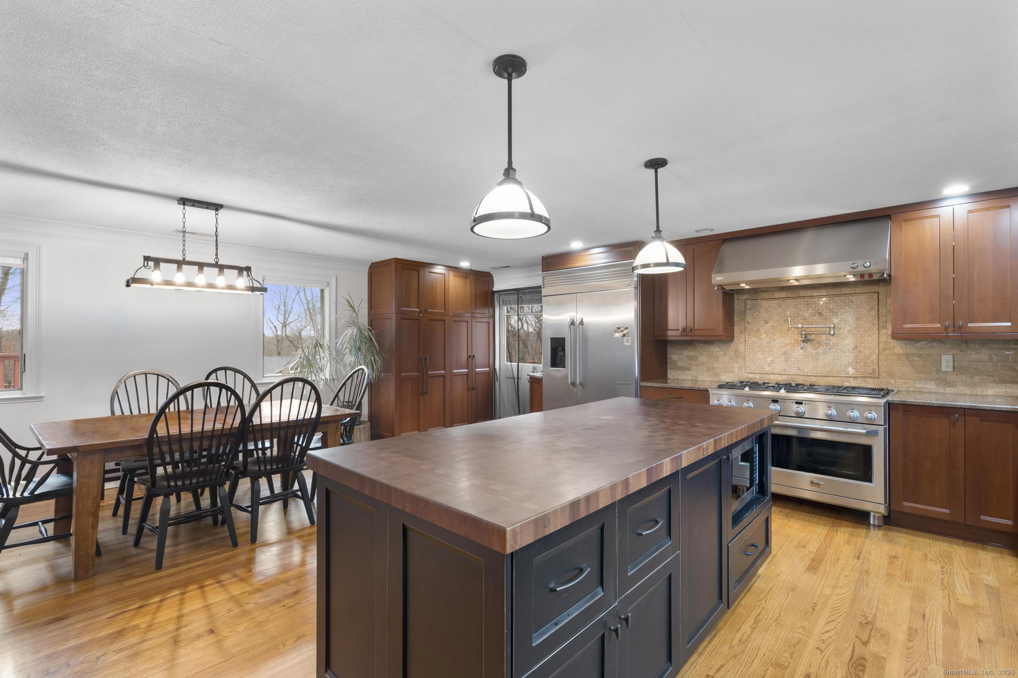 57 Gray Rock Road Trumbull, CT 06611 - Photo 5 of 40 a kitchen with stainless steel appliances kitchen island a large island in the center and wooden floor