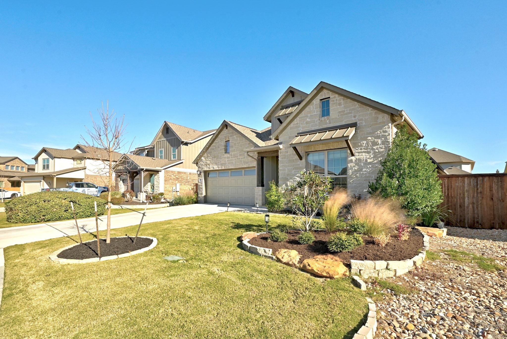108 Leon Loop Liberty Hill, TX 78642 - Photo 2 of 39 Craftsman inspired home with concrete driveway, stone siding, and a garage