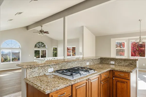 a kitchen with stainless steel appliances granite countertop a stove and a sink