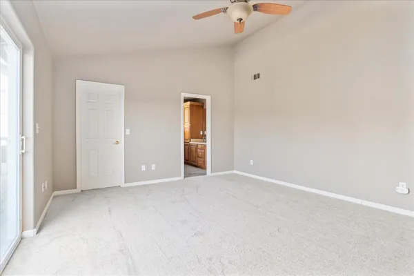 an empty room with fan and window