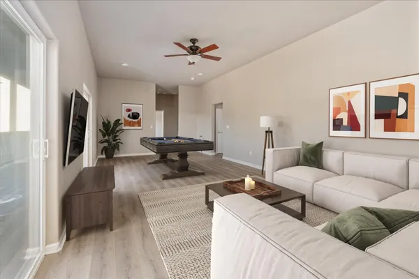 a living room with furniture and a chandelier