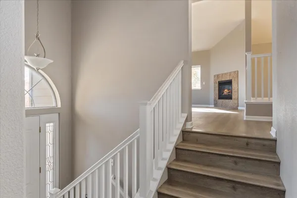a view of entryway and hall with wooden floor