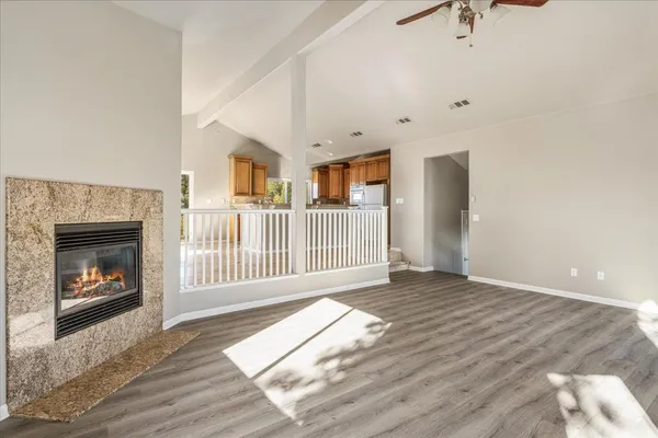a view of a livingroom with a fireplace and wooden floor