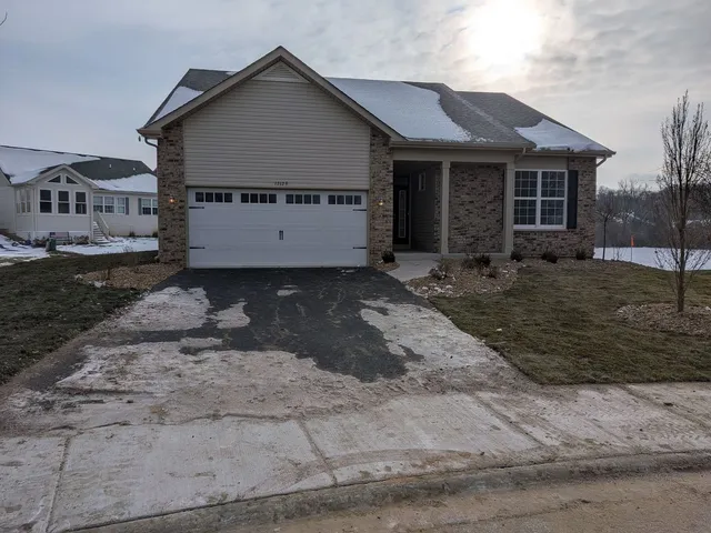 a view of a grey house with a yard