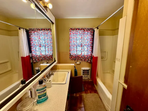 a bathroom with a shower curtain and a window