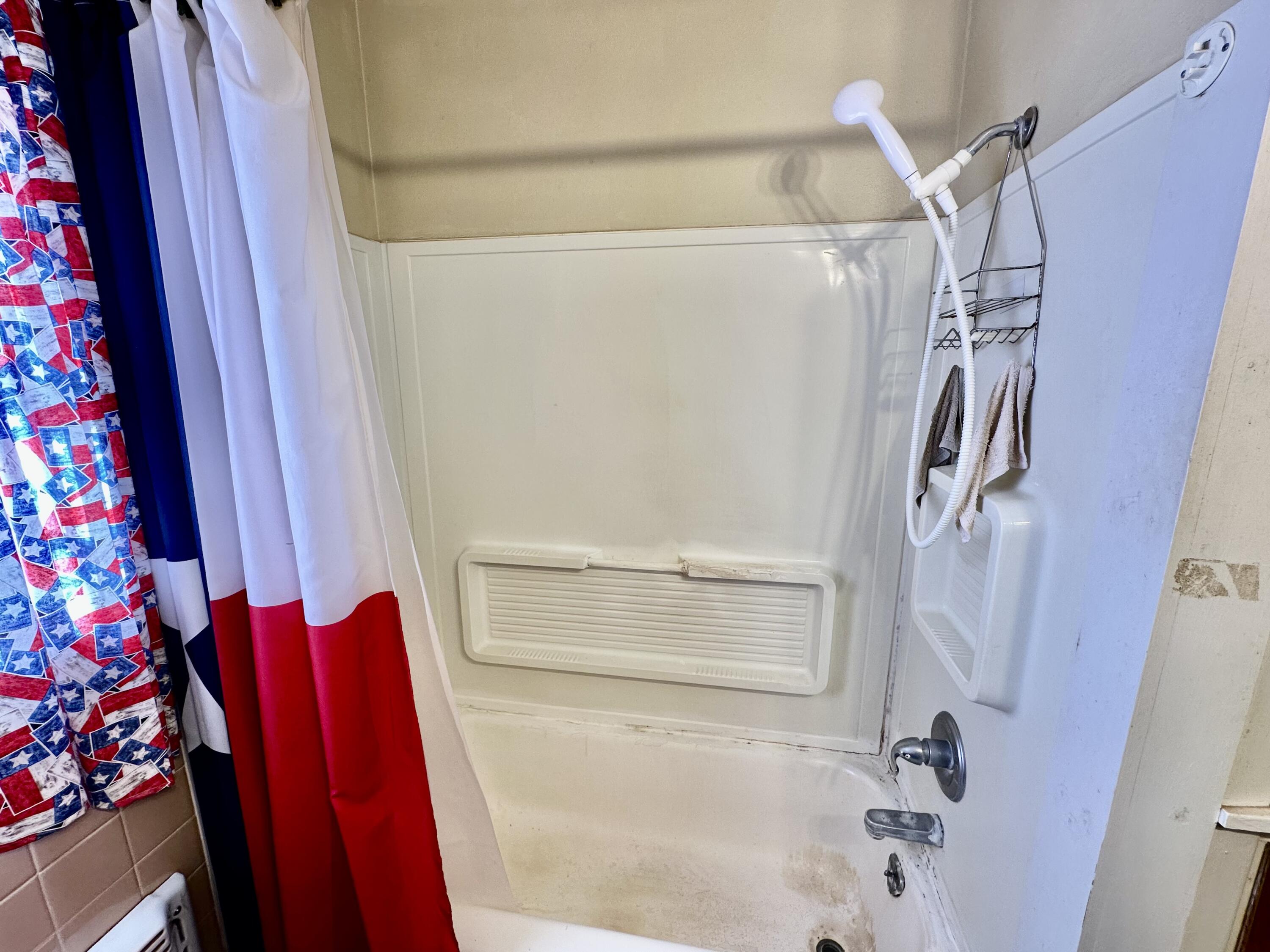 488 Co Road 4 Turkey, TX 79261 - Photo 16 of 29 a bathroom with a shower curtain and a window