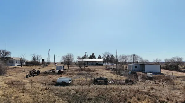 a view of a room with wooden floor and furniture