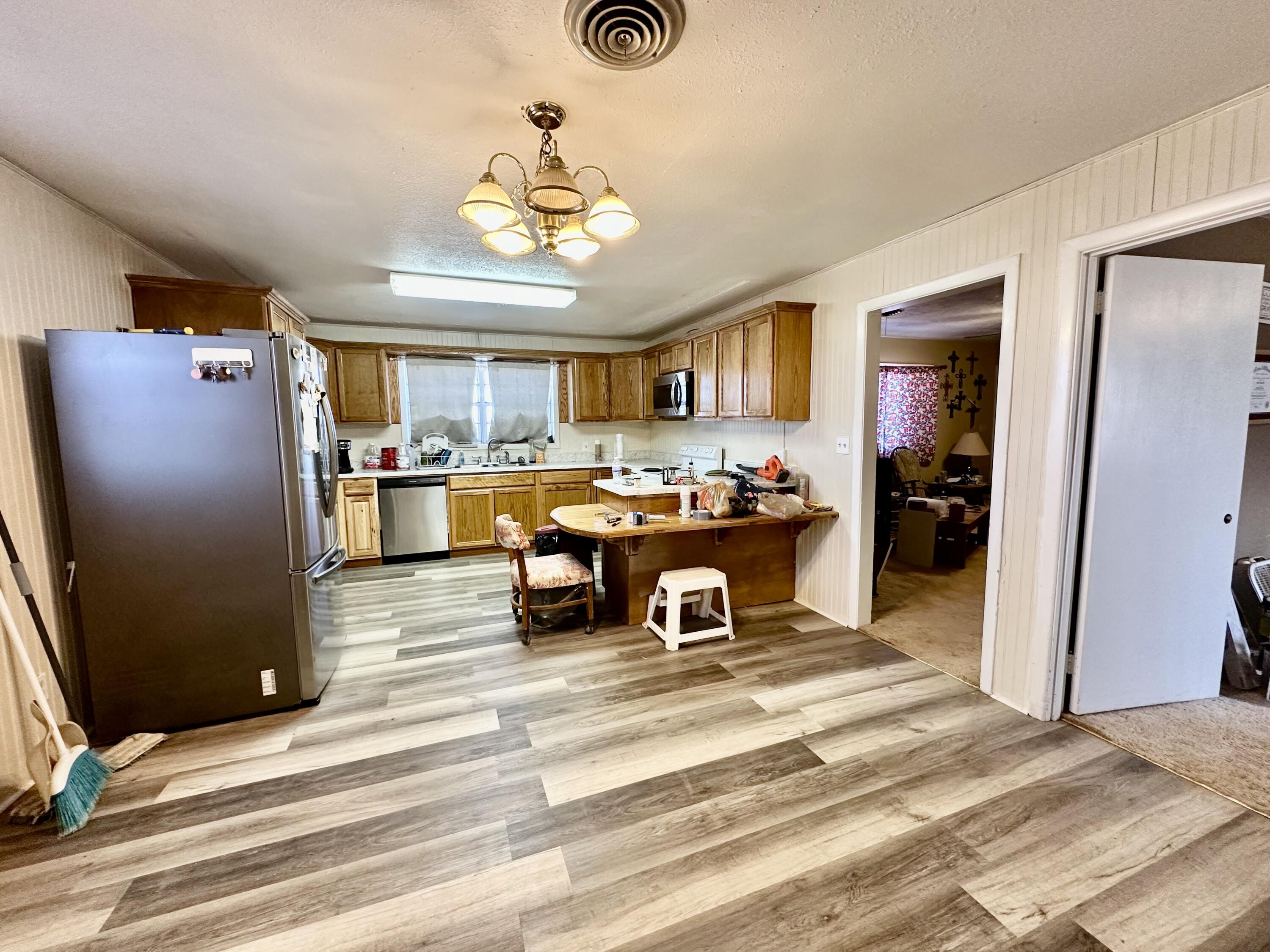 488 Co Road 4 Turkey, TX 79261 - Photo 7 of 29 a view of a room with wooden floor and furniture