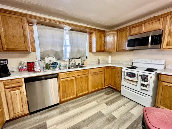 a view of a livingroom with lounge chair and a ceiling fan