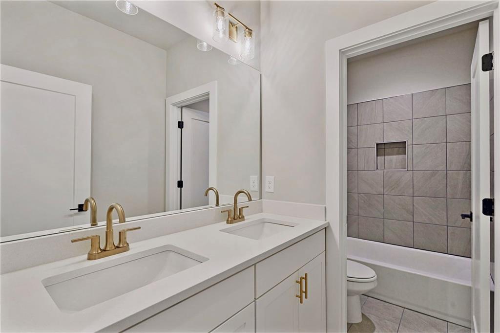 1697 Eastside Parc Street Atlanta, GA 30316 - Photo 32 of 44 a bathroom with a sink a toilet and shower