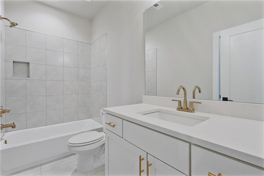 1697 Eastside Parc Street Atlanta, GA 30316 - Photo 9 of 44 a bathroom with a sink a toilet and bathtub