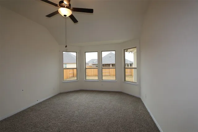 a large kitchen with stainless steel appliances kitchen island a large counter top and a wooden floor