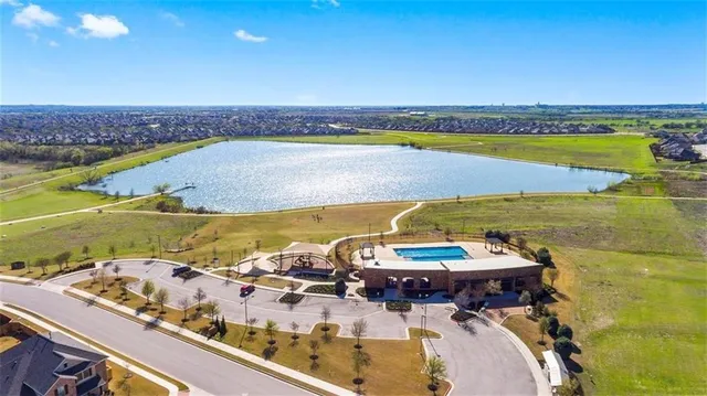 a childrens park with lots of trees and slides